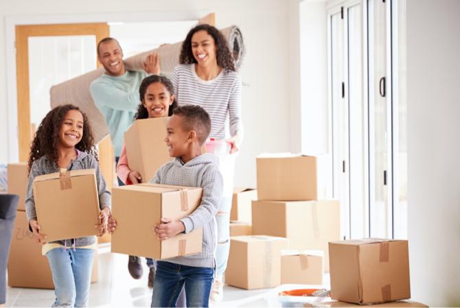 A family carrying moving boxes.